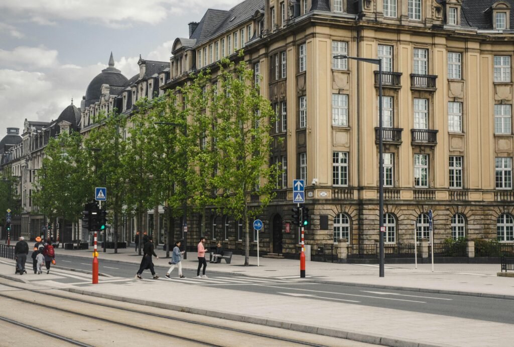 Charming street scene in Luxembourg City featuring classic architecture and city life.