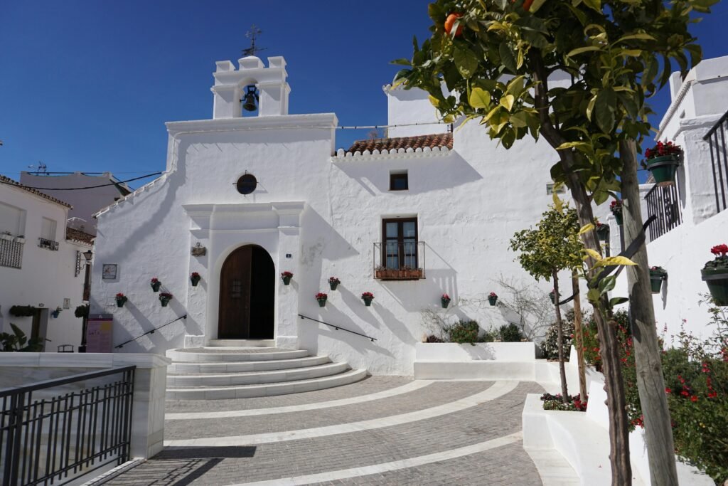 Beautiful white church facade in sunny Mijas, Spain, showcasing classic architecture.