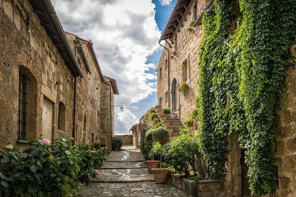 Historic stone houses adorned with ivy in a picturesque Mediterranean street.