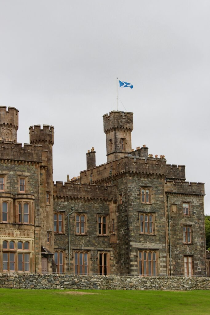 A striking Scottish castle with medieval architecture, showcasing a distinctive stone facade and turrets.